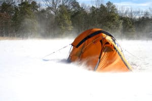 orange tent in winter storm