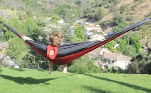 man relaxing in hammock
