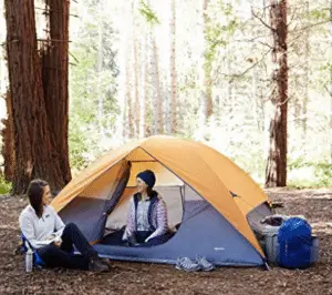 two women talking at camping tent