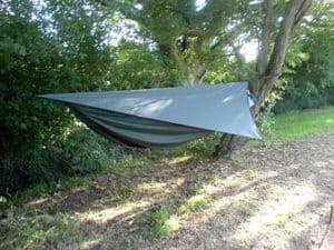 green tarp over green hammock