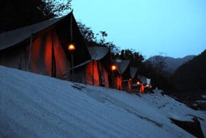 line of tents with lanterns at dusk