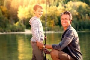 Dad fishing with son on dock