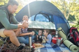 Family hanging out in tent