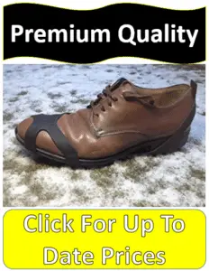 brown shoe with crampon on snowy grass