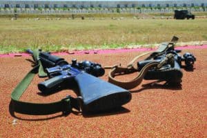 two assault rifles with web gun slings