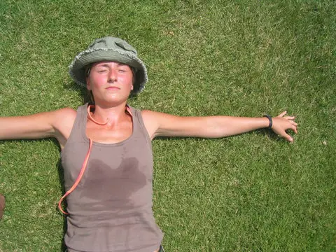 resting woman hiker on grass