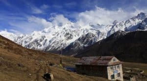 Nepal mountain peak over stone hut