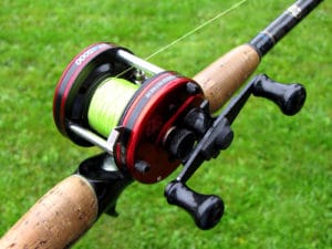 baitcasting reel spooled over grass