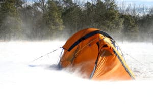 orange tent battered in snow storm
