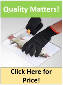 gloved hands filleting fish on cutting board