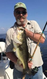 angler on boat with big bass