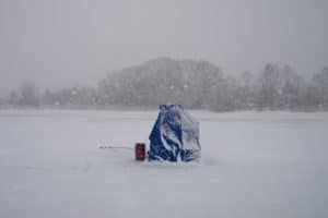 temporary ice fishing shelter in snow storm