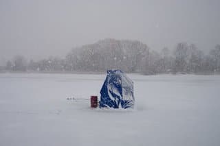 temporary ice fishing shelter in snow storm
