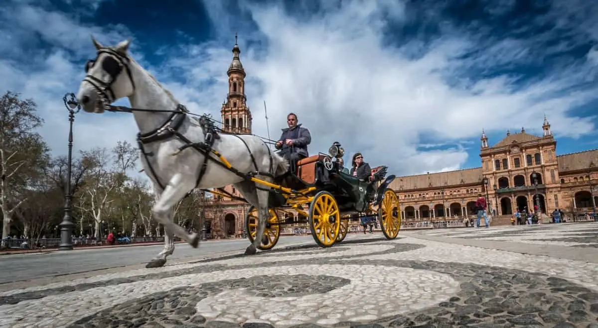 Two passengers in horse drawn carriage Seville Spain