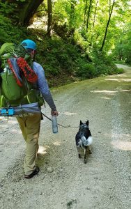 backpacker with dog on trail