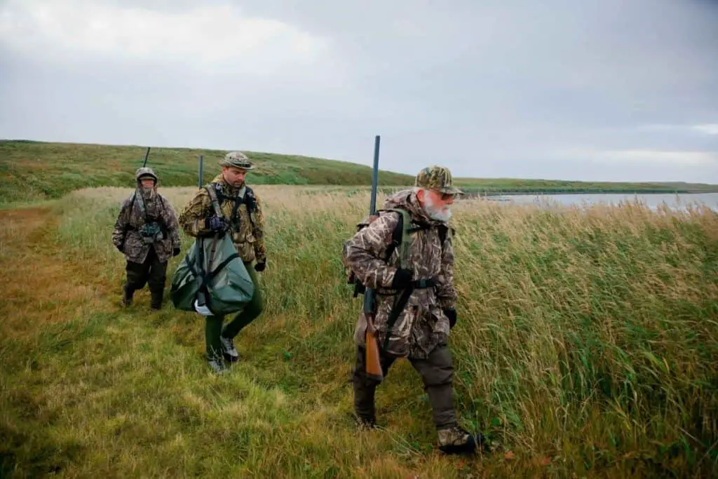 three duck hunters in camo