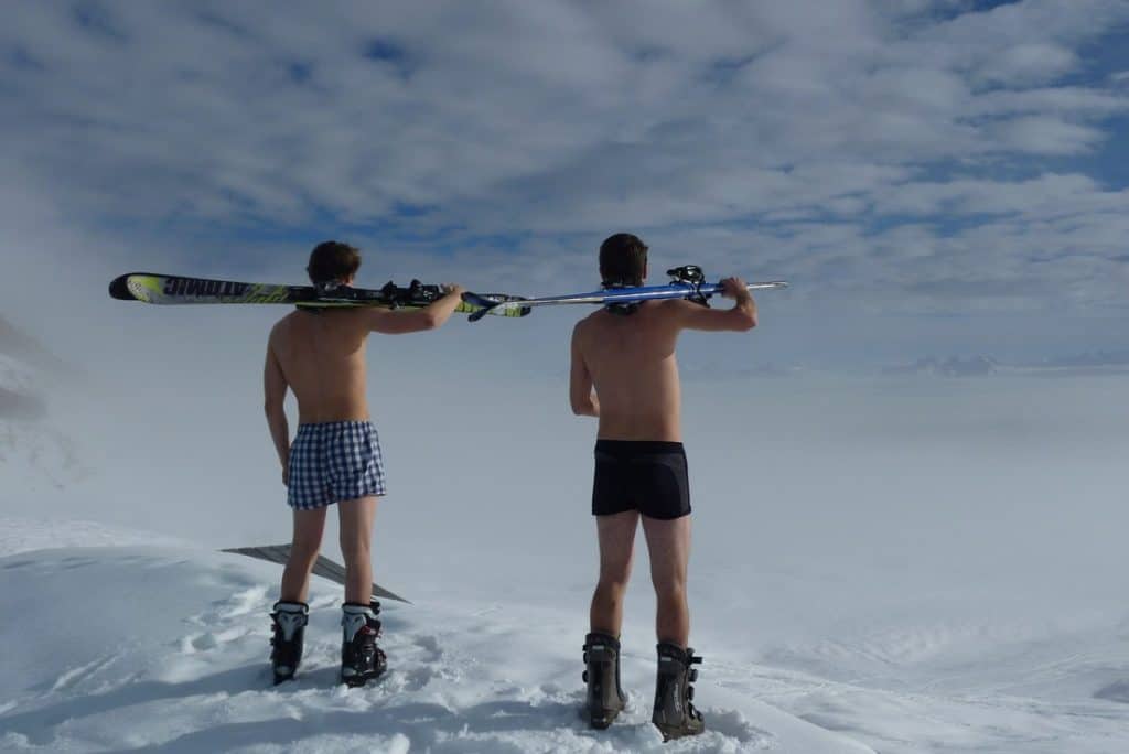 two skiers standing in underwear