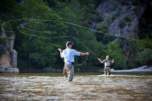 two men fly fishing trout stream